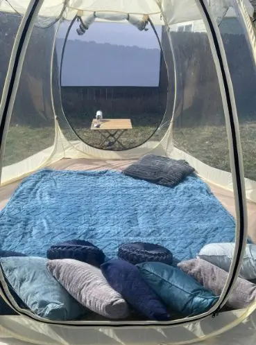 Outdoor movie night setup in Newport Oregon with projector and clear bubble lounge