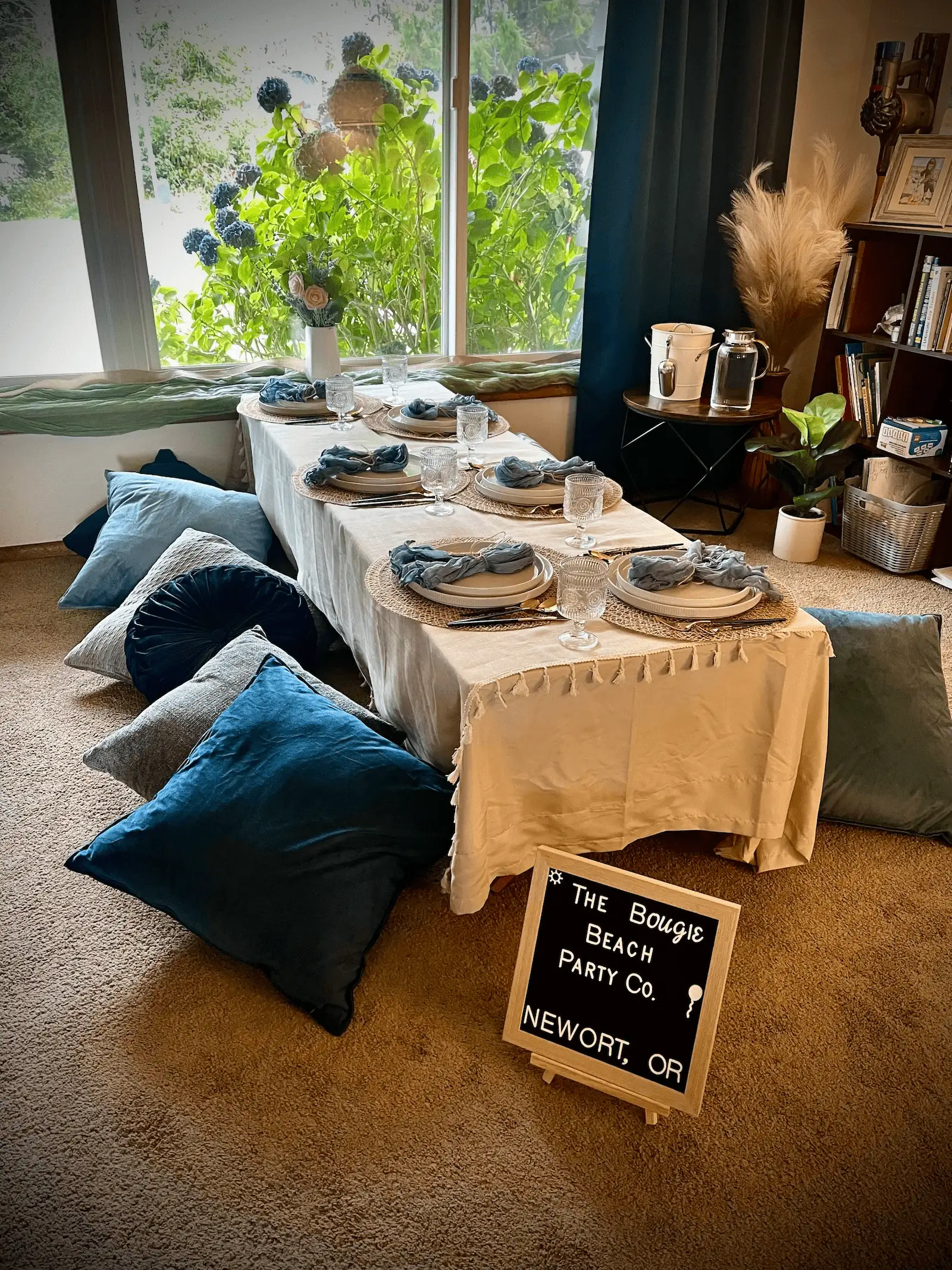 Indoor luxury tablescape setup in Newport Oregon with cushions and styled decor