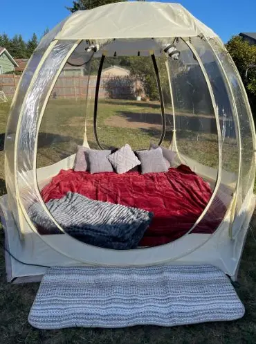 Backyard watch party in Newport Oregon with projector screen and bubble setup